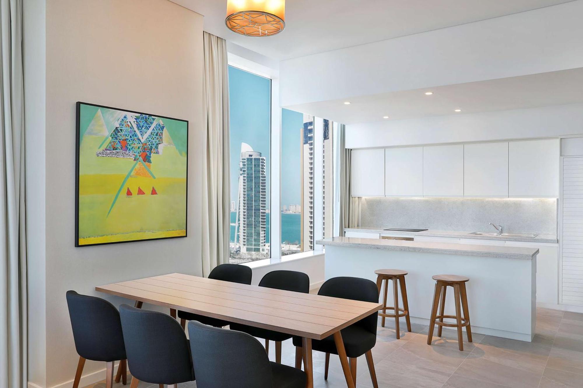 Aleph Doha Residences, Curio Collection By Hilton Ngoại thất bức ảnh The kitchen and dining area of a typical apartment